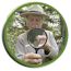 Ranger peering through magnifying glass